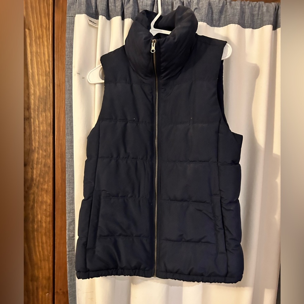 Old navy blue puffer vest worn